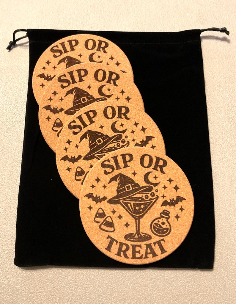 Four laser etched Sip or Treat cork coasters arranged on a black velvet drawstring pouch, packaged as a ready-to-give gift set