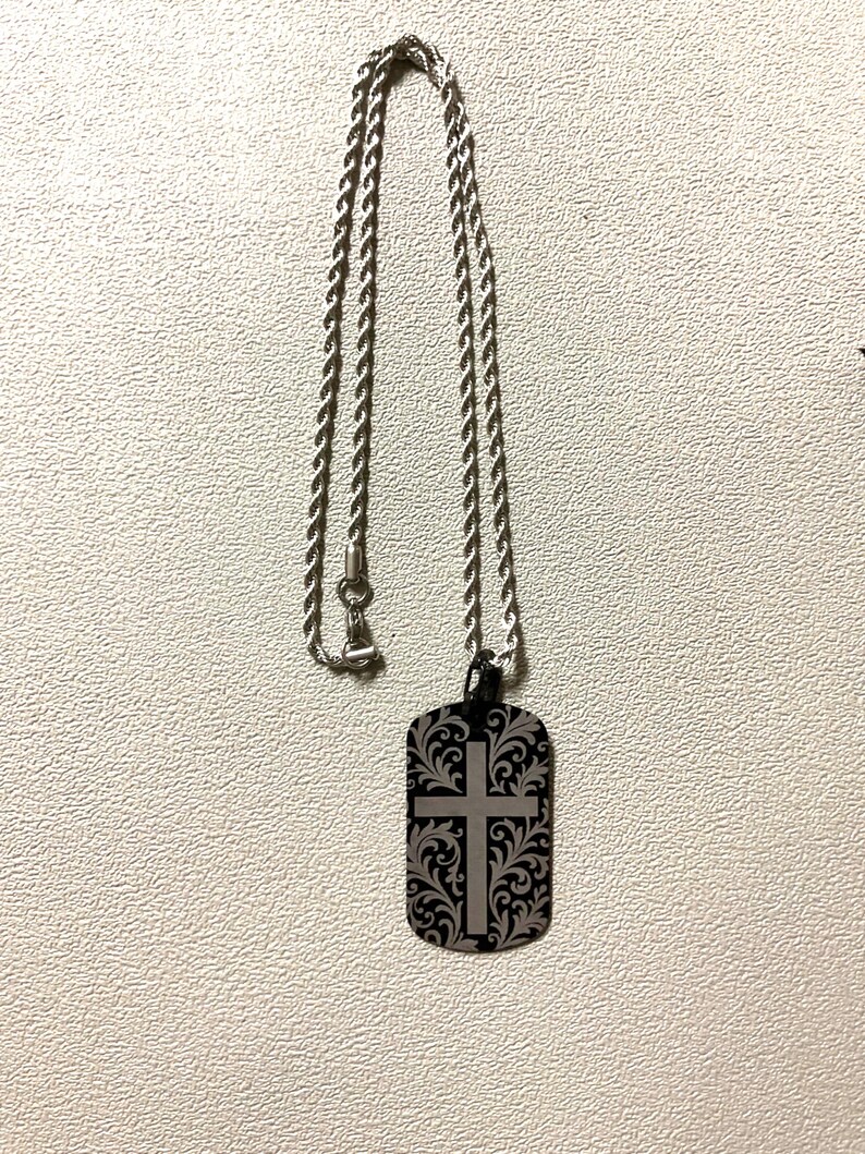 Custom laser engraved crucifix cross aluminum dog tag on a stainless steel rope chain, made by Robert Anthony Art in Vacaville, California