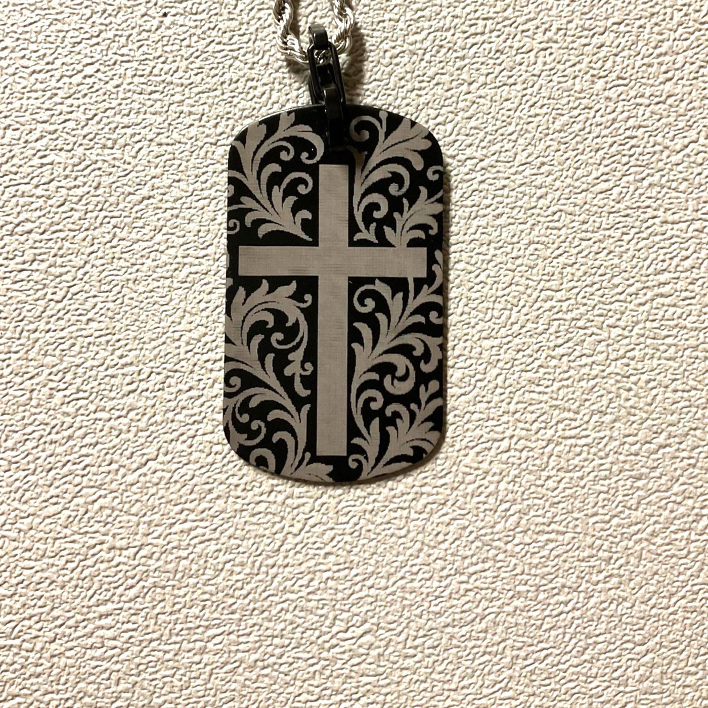 Laser engraved crucifix cross dog tag with ornate scrollwork on a rope chain