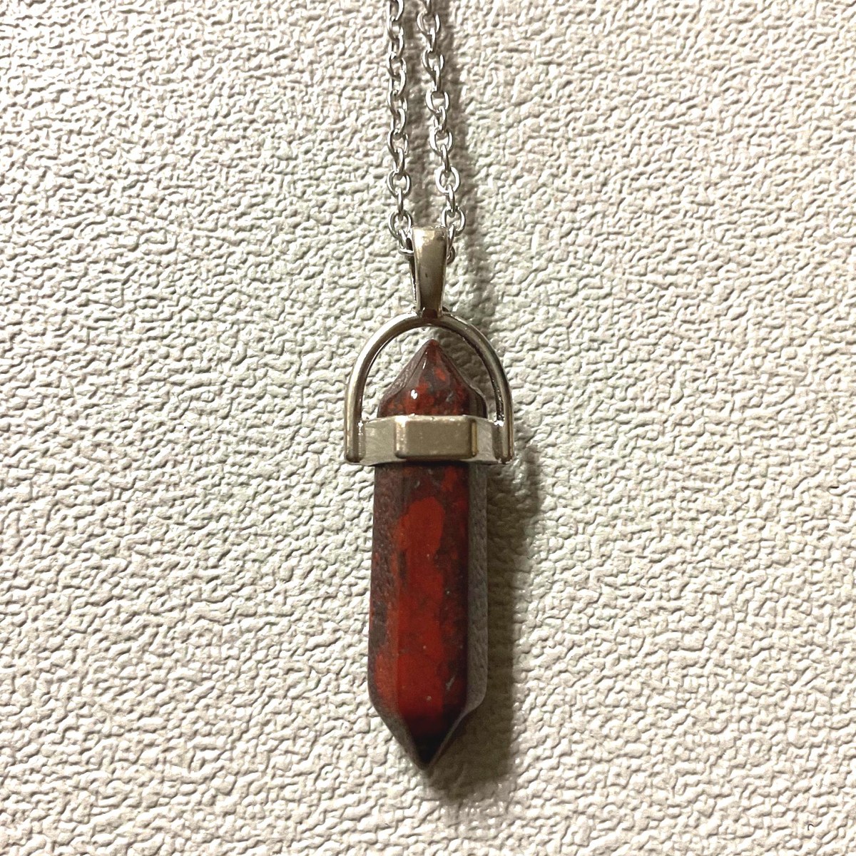 Mahogany obsidian pendant with reddish brown tones on a chain