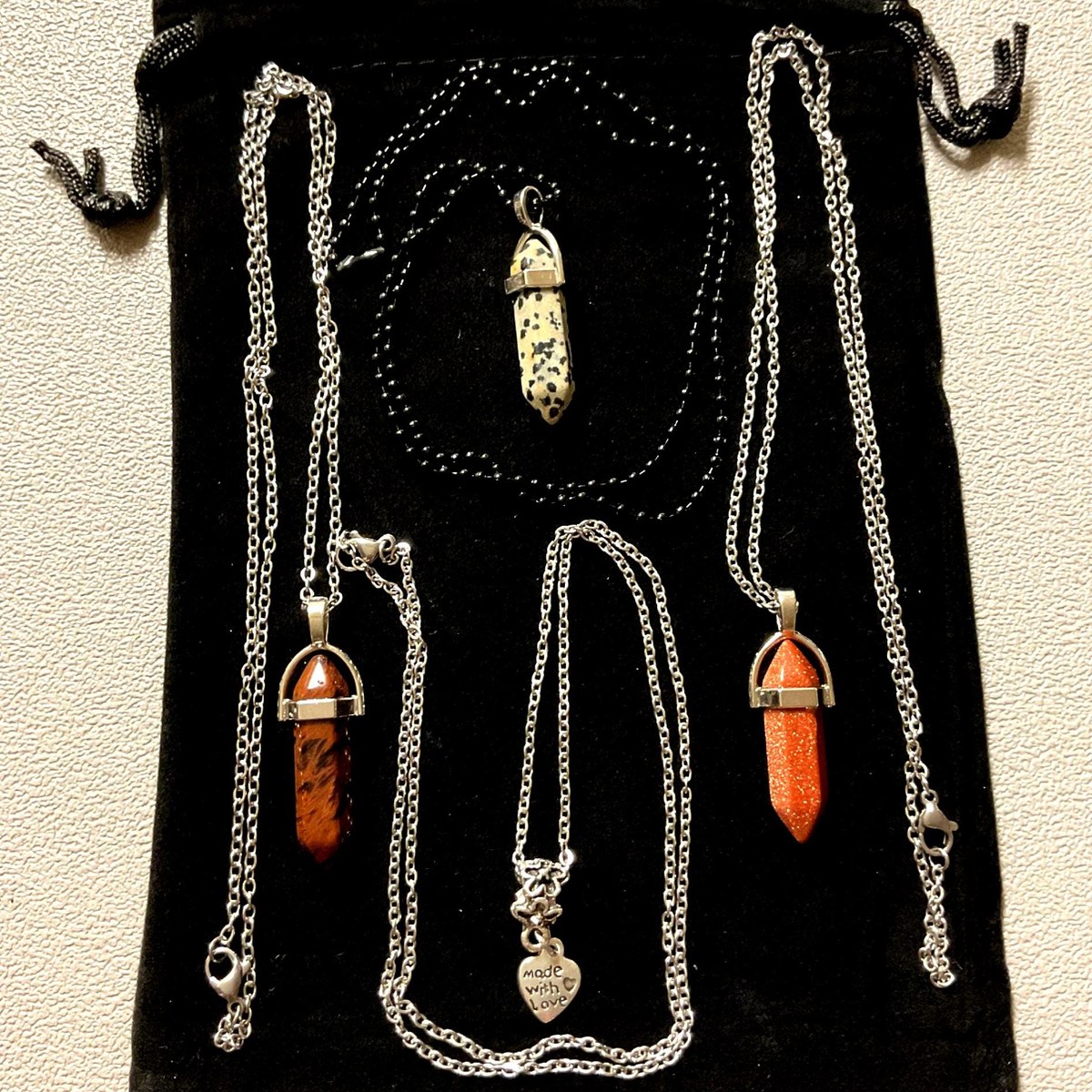 Mahogany obsidian and jasper stone pendants paired with heart charm necklaces