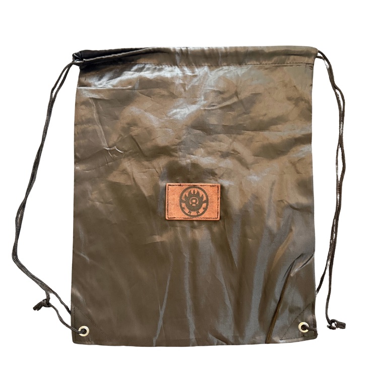 Olive drawstring cinch bag branded with a laser engraved leather patch sewn to the front panel, made by Robert Anthony Art in Vacaville, California